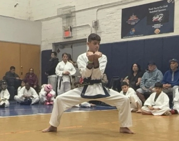 karate student during karate competition wearing a white karate uniform and belt